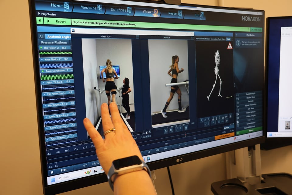 Doctor of Physical Therapy reviewing biomechanics data on Noraxon software